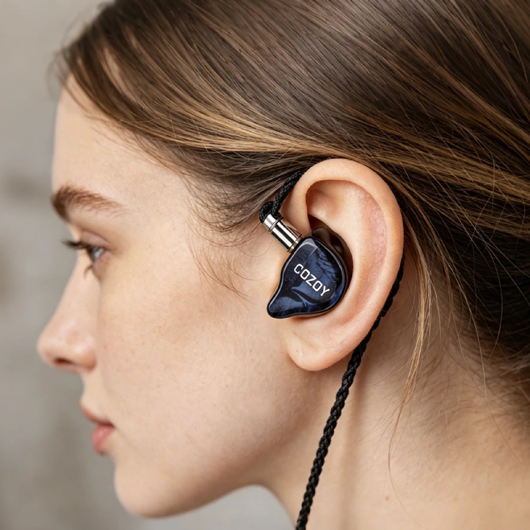 COZOY D2 in-ear monitor worn in the ear, showing its ergonomic fit