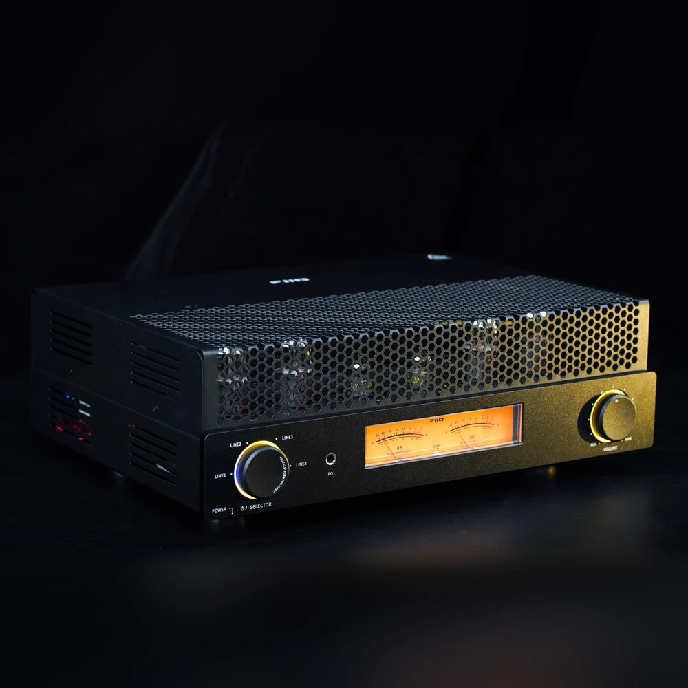 FiiO EA13 black tube amplifier with illuminated knobs and VU meters in a dark studio