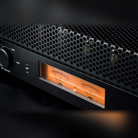 Close-up of the FiiO EA13 dual-channel backlit mechanical VU meters