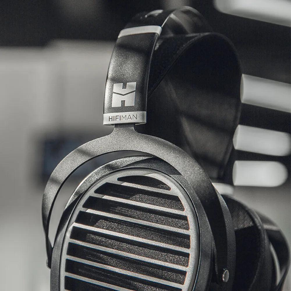 Close-up of the HIFIMAN Ananda Stealth earcup grille and logo yoke