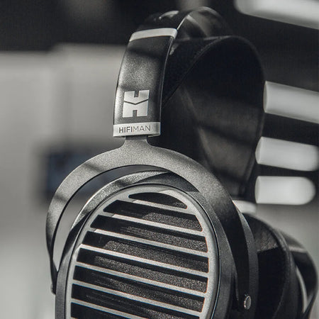 Close-up of the HIFIMAN Ananda Stealth earcup grille and logo yoke