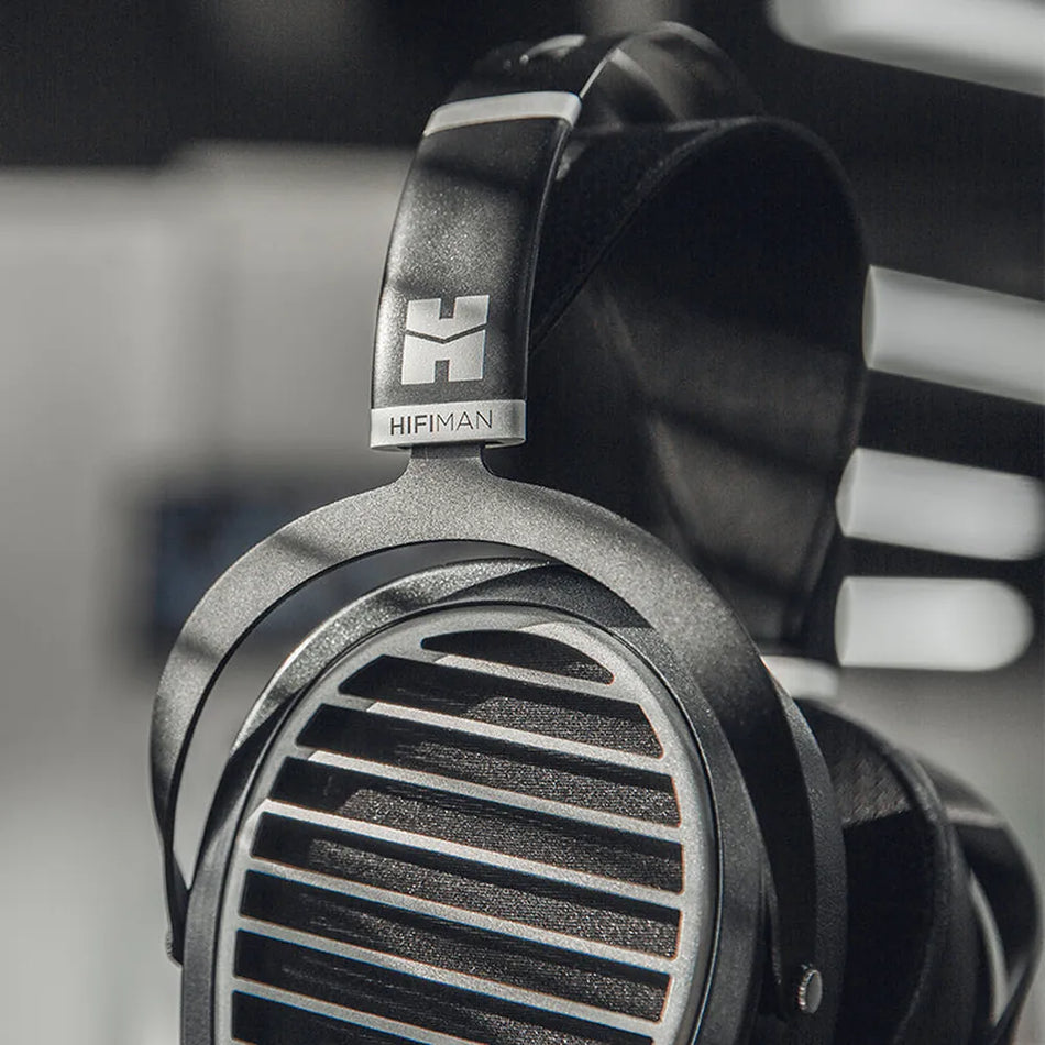 Close-up of the HIFIMAN Ananda Stealth earcup grille and logo yoke