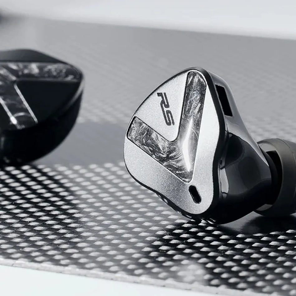 Softears RSV MK2 earphones close-up on carbon-fibre textured surface showing RS logo faceplate