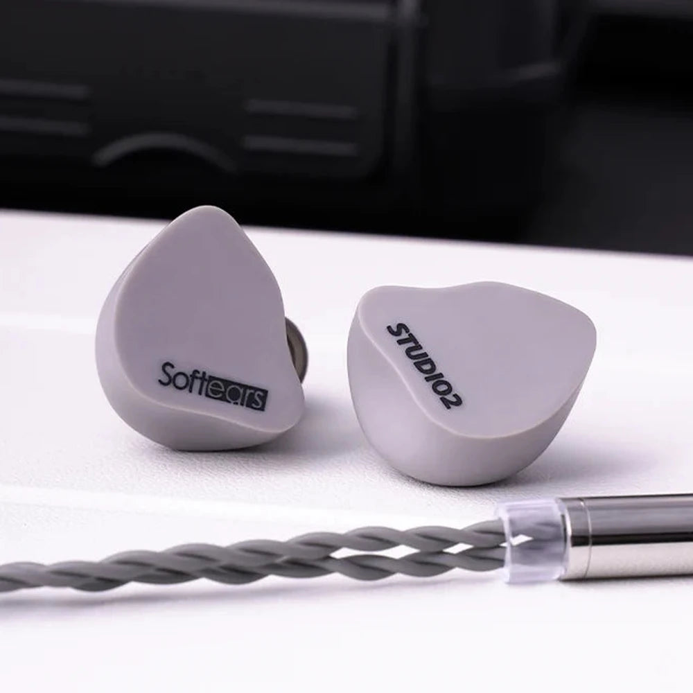 Softears Studio 2 earphones with carrying case in background
