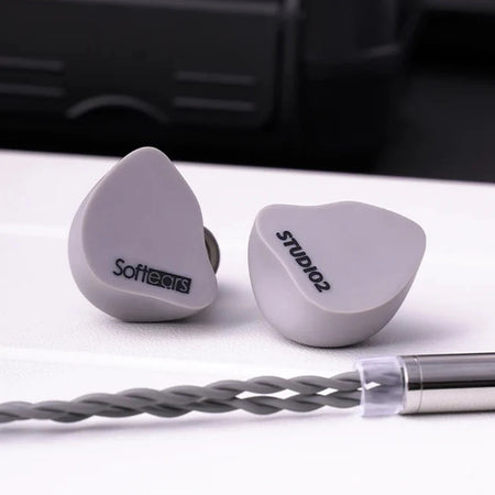 Softears Studio 2 earphones with carrying case in background