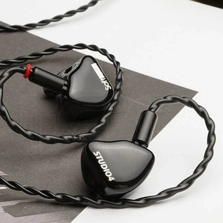 Softears Studio 4 earphone pair resting on paper background